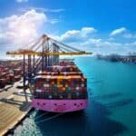 Cargo ship loaded with containers at a Dubai shipping company port. Global trade and logistics.